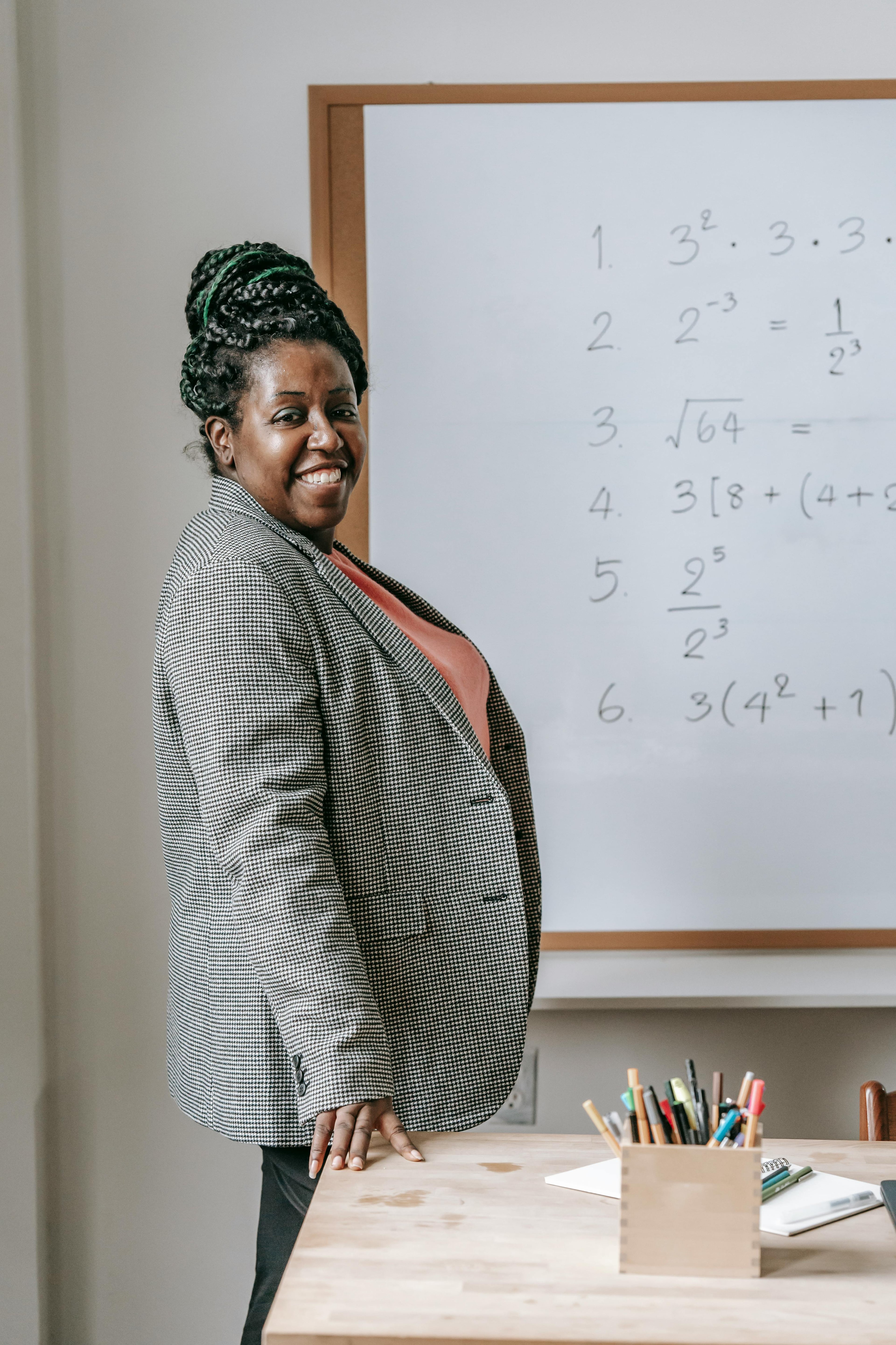 A smiling trainer preparing for class in a classroom